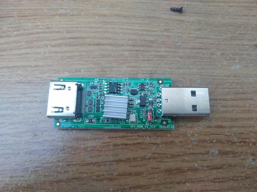 Picture of HDMI capture dongle on desk, out of its case