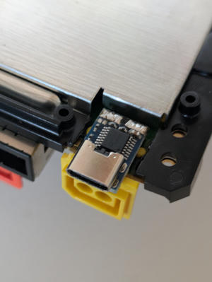 A USB-C PD board soldered to the back of the Wii U power connector. It fits well.